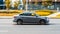 Lada Vesta in motion, side view. Popular Russian sedan car on city streets