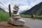 LADAKH, JAMMU AND KASHMIR, INDIA, July 2018, Local man pass by stone pyramid made with loose stones for good fortune