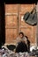 Ladakh, Leh, India - November 6, 2021 : poor indian girl selling accessories mobile case, leather belt and wallet in stall at