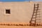 ladder leaning against a pueblo adobe wall