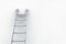 Ladder leaning on white wall