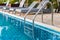 Ladder stainless handrails for descent into swimming pool. Swimming pool with handrail . Ladder of a swimming pool. Horizontal sh