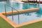 Ladder stainless handrails for descent into swimming pool. Swimming pool with handrail . Ladder of a swimming pool. Horizontal sho