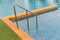 Ladder stainless handrails for descent into swimming pool. Swimming pool with handrail . Ladder of a swimming pool. Horizontal sho