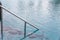 Ladder stainless handrails for descent into swimming pool. Swimming pool with handrail . Ladder of a swimming pool. Horizontal sho