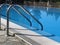 Ladder in swimming pool. Pool water. Copy space. Vacation concept