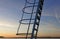 Ladder to jumping tower in sunset