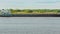 Laden self-propelled barge floating on the river