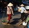 Ladies in coolies selling food in Hanoi Vietnam