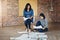 The ladies are hard at work. two businesswomen brainstorming on the floor in an office.