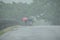 Ladies with umbrellas on a route from in Raigad, Maharashtra, India during a heavy rain