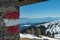 Ladinger Spitz - Directional path mark coloured in Austrian flag on the stone wall of a mountain cottage near Ladinger Spitz