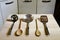 Ladles on wooden table on kitchen background