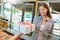 Lady accepting gift wrapped box in bakery