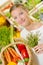 Lady adding herbs to purchases in basket