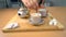 Lady adding a sugar cube into a cup of tea - Indian tea preparation