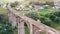 Lady athlete is running along an old bridge