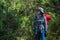 Lady backpacker or trekker with backpack lost in jungle in Nepal