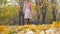 Lady In Beige Coat And Orange Scarf Walking On Autumn Carpet Of Yellow Leaves 4k