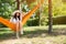 Lady with big hat sitting in hammock