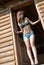 Lady with bikini top and jean shorts in wooden cabin