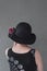 Lady with black hat and dahlia