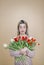 The lady with with closed eyes, holding bouquet of many tender red tulips