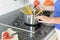 Lady cooking spaghetti pasta on her stove