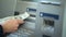 Lady counting dollars withdrawn from ATM, putting cash in purse, easy banking