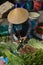 Lady cutting courgette in Can Tho food market, Vietnam