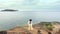 Lady is dancing next to the precipice of rock on ocean background filmed in timelapse