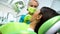 Lady dentist curing female patient tooth, health of oral cavity, modern clinic