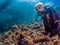 Lady diver with school of diamondfish