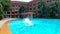 A lady is diving into a hotel swimming pool