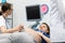 A lady doctor checks the abdomen of a pregnant patient with an ultrasound. Gynecology office.