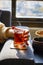 The lady drinking Turkish tea in a thin-waisted glass cup. black tea.