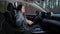 Lady driver fastens seat belt sitting at car steering wheel