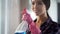 Lady easily cleaning windows and mirrors from dust and stains with new detergent