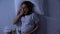 Lady expectant lying in bed feeling nausea, morning sickness, pregnancy health