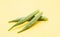 Lady Finger or okra isolated on yellow background,fresh cooking ingredient