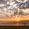 Lady flying a kite on the sunset on Goa beach