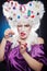 Lady focused with accessories for needlework in her wig