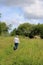 Lady on footpath walking through wild flower area