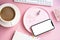 Lady freelancer's home pastel pink workplace, cup of coffee and smartphone mock-up