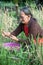 lady gathering hay from paddy field