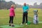 Lady golfer being taught by a golf pro.