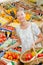 Lady in grocers choosing fruit and vegetables