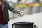 Lady hand throwing garbage to a trash bin