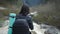 Lady hiker with backpack looking on hills and mountain river lake, girl enjoying nature panoramic landscape in trip