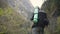 Lady hiker with backpack looking on hills and mountain river lake, girl enjoying nature panoramic landscape in trip